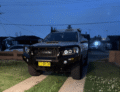 Defender bar on a Toyota Hilux 2012-2015 parked in driveway at dusk
