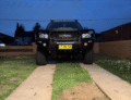 Front view of a black Toyota Hilux 2012-2015 with a heavy-duty bull bar.